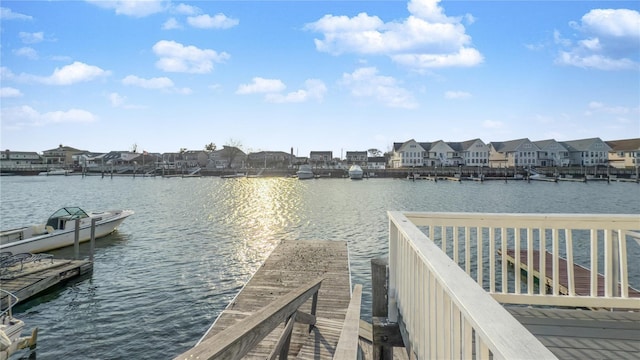 view of dock with a water view and a residential view