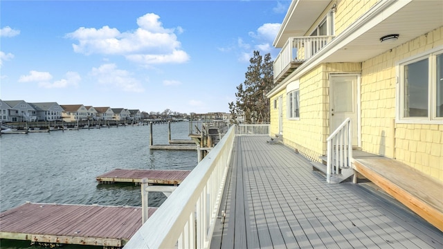 dock area featuring a residential view and a water view