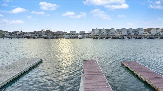 view of dock with a water view and a residential view