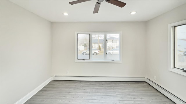 empty room featuring baseboards, baseboard heating, recessed lighting, and light wood-style floors