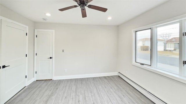 spare room with recessed lighting, a ceiling fan, baseboards, baseboard heating, and light wood finished floors