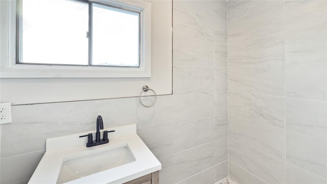 bathroom featuring tile walls and vanity