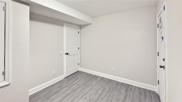 interior space with light wood finished floors and baseboards