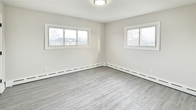 unfurnished room featuring plenty of natural light and wood finished floors