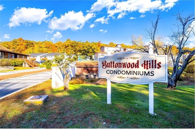 community / neighborhood sign with a lawn