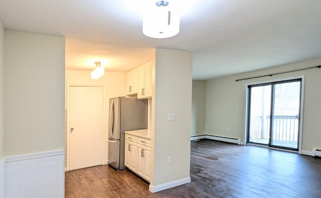 kitchen with dark wood-style floors, a baseboard radiator, light countertops, freestanding refrigerator, and white cabinets