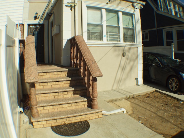 property entrance with stucco siding