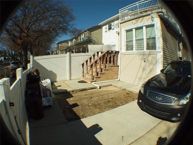 view of side of home with fence