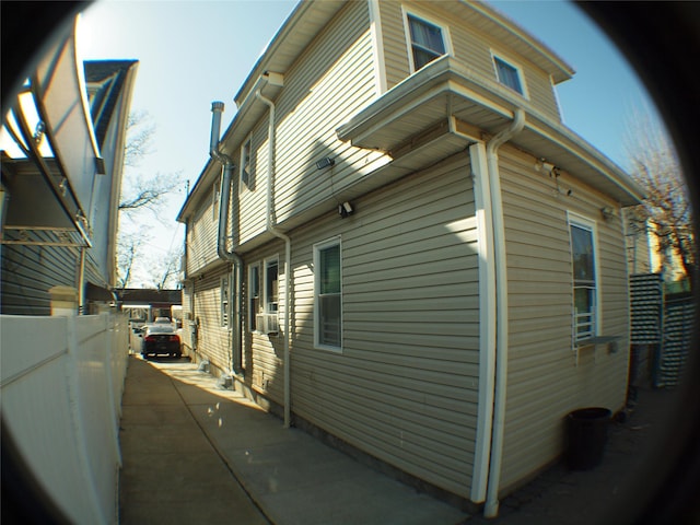 view of side of property featuring fence