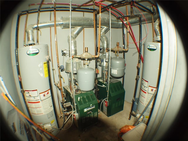 utility room featuring gas water heater and a heating unit