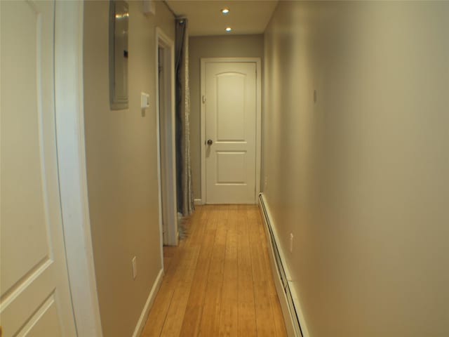 hall featuring recessed lighting, a baseboard radiator, baseboards, and light wood-style floors