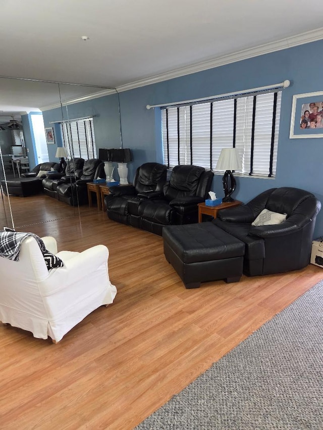 living area featuring crown molding and wood finished floors