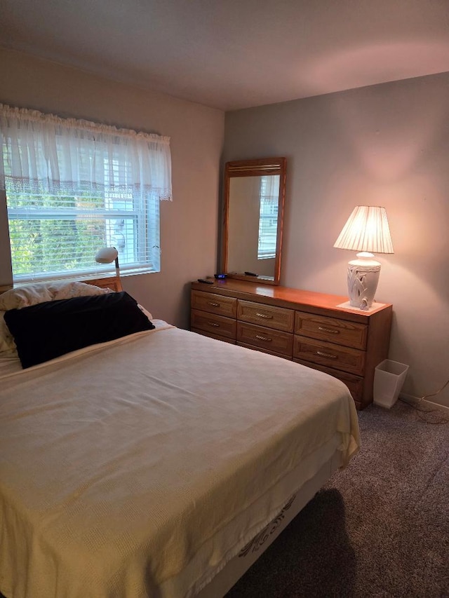 carpeted bedroom with baseboards