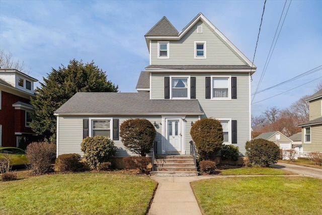 traditional home featuring a shingled roof and a front yard