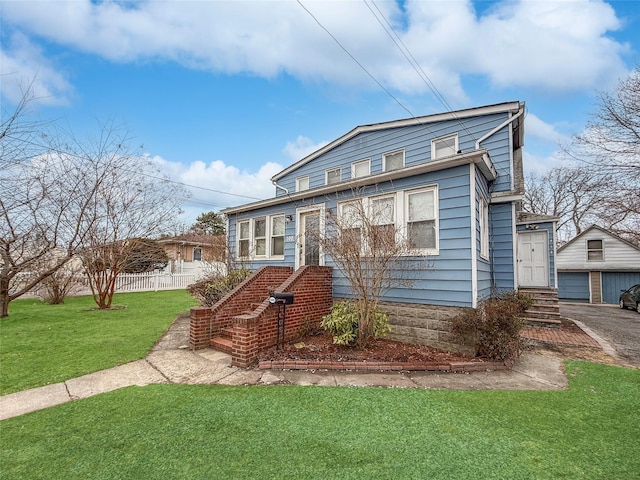 view of front facade with a garage, a front yard, and fence