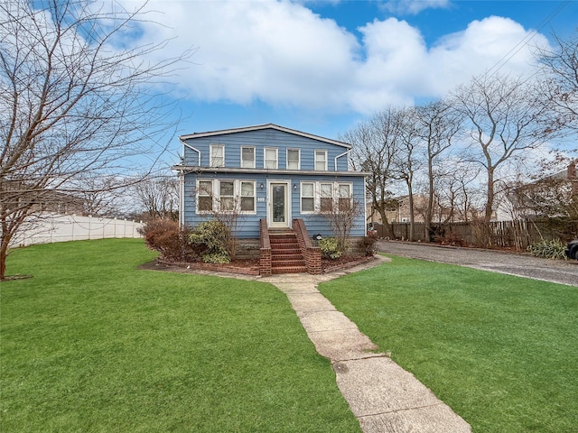 view of front facade with a front yard and fence