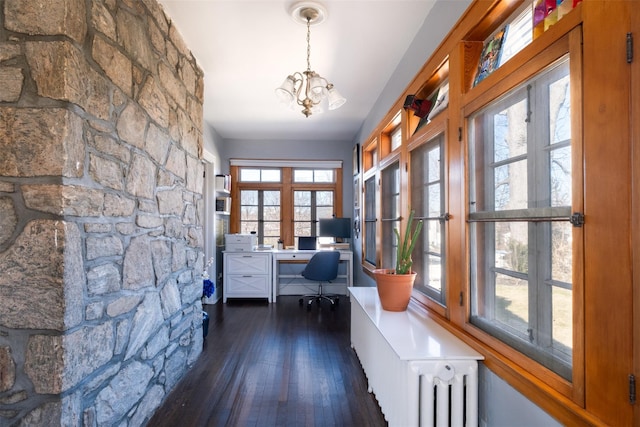 unfurnished office featuring a chandelier, radiator, and wood finished floors