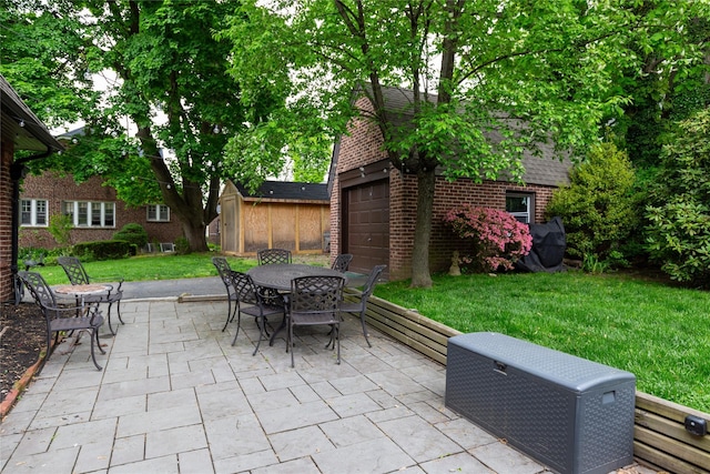 view of patio / terrace featuring a storage shed, an outdoor structure, and outdoor dining area