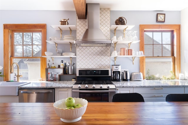 kitchen with a sink, open shelves, stainless steel appliances, island range hood, and decorative backsplash