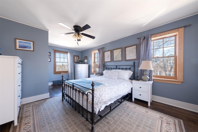 bedroom with baseboards, wood finished floors, and ornamental molding