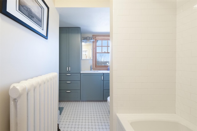 bathroom with tile patterned floors, radiator, vanity, and shower / bathing tub combination