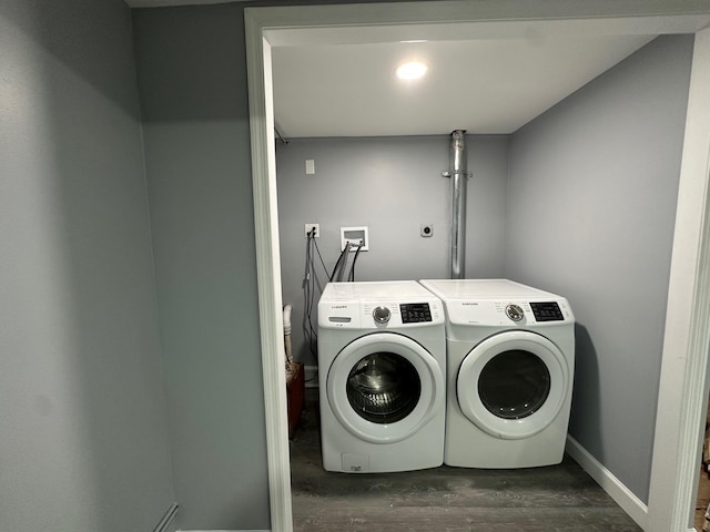 laundry area featuring laundry area, baseboards, washing machine and clothes dryer, and wood finished floors