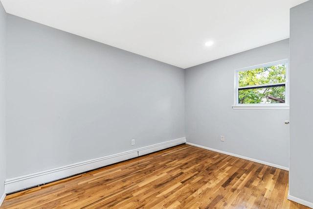 empty room with light wood-style floors, baseboards, and baseboard heating