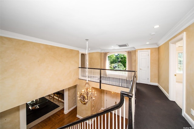 hallway with recessed lighting, crown molding, visible vents, baseboards, and an inviting chandelier