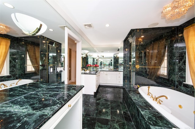 bathroom featuring visible vents, vanity, a marble finish shower, and a tub with jets