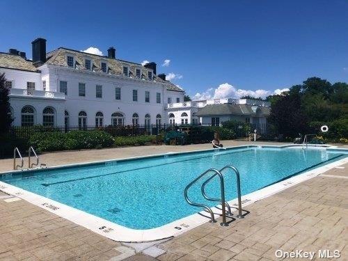 community pool featuring fence and a patio