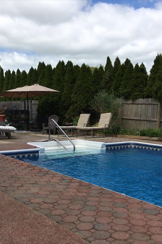 view of pool with a patio area, fence, and a fenced in pool