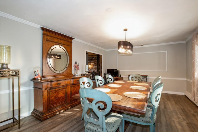 dining space featuring baseboards, ornamental molding, and dark wood finished floors