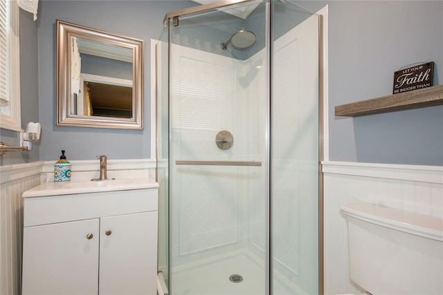 full bath featuring a stall shower, vanity, and toilet