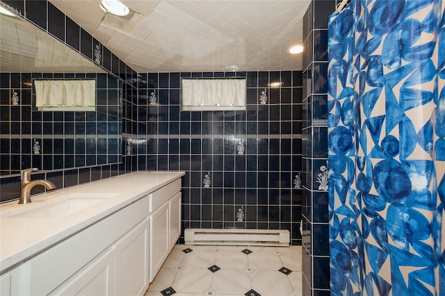 bathroom featuring curtained shower, baseboard heating, tile walls, and vanity