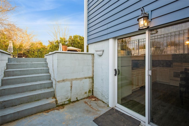 doorway to property featuring fence