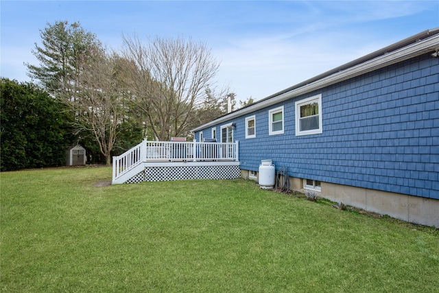 view of yard with an outbuilding, a storage unit, and a deck