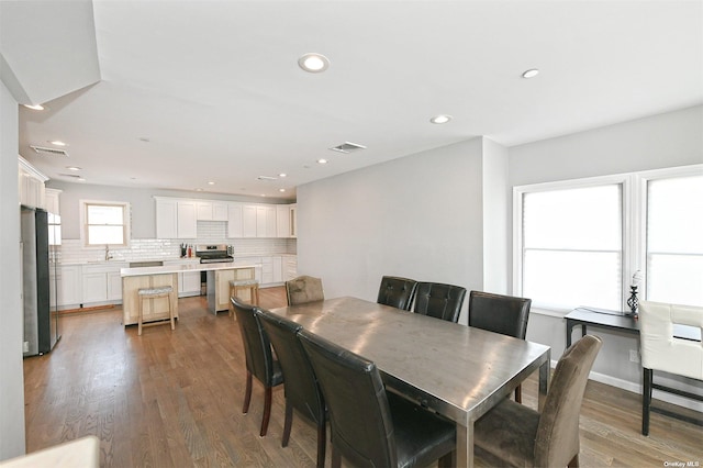 dining space featuring wood finished floors, visible vents, and recessed lighting