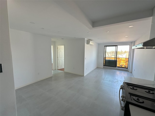 empty room with recessed lighting, baseboards, and a wall mounted AC