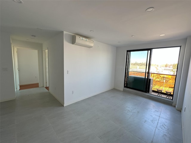 empty room featuring recessed lighting, baseboards, and a wall mounted AC