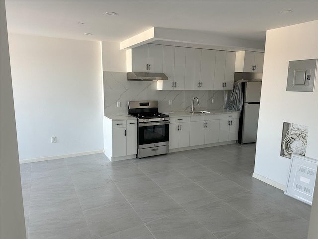 kitchen featuring tasteful backsplash, under cabinet range hood, electric panel, stainless steel appliances, and a sink