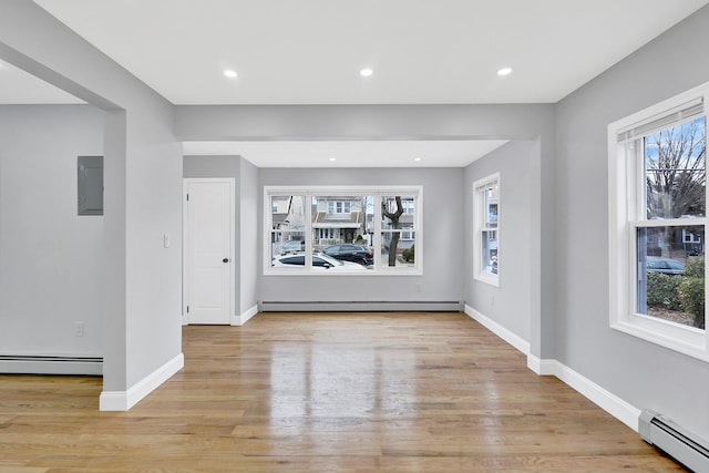 interior space with a baseboard radiator and baseboards