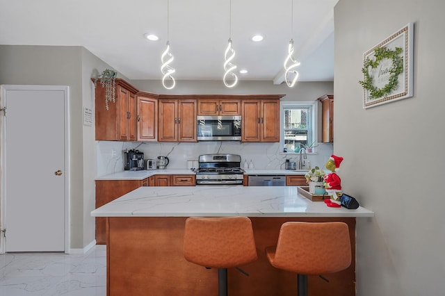 kitchen featuring a sink, marble finish floor, appliances with stainless steel finishes, tasteful backsplash, and brown cabinetry