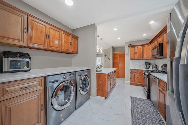 laundry room with marble finish floor, washing machine and dryer, laundry area, and recessed lighting