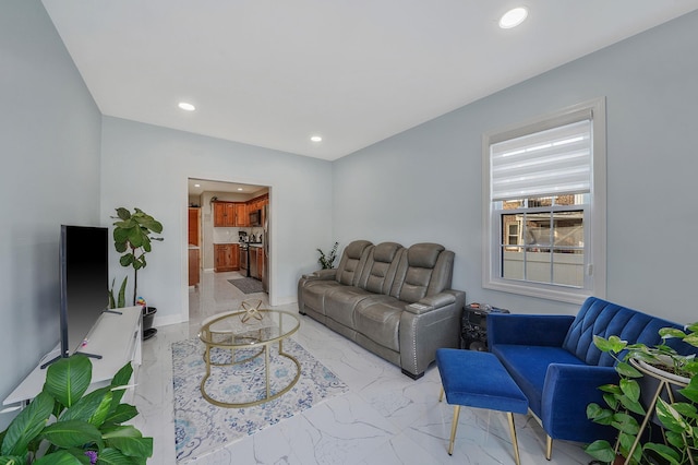 living area with recessed lighting, marble finish floor, and baseboards