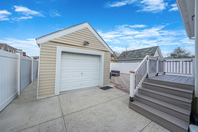 detached garage with driveway and fence