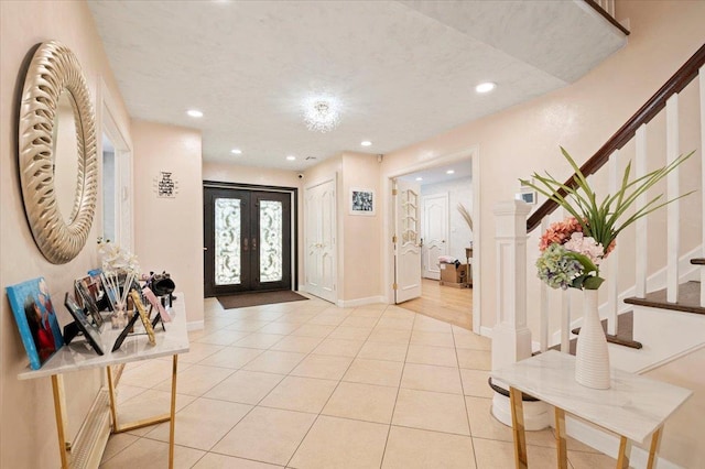 foyer entrance with baseboards, stairs, light tile patterned flooring, french doors, and recessed lighting