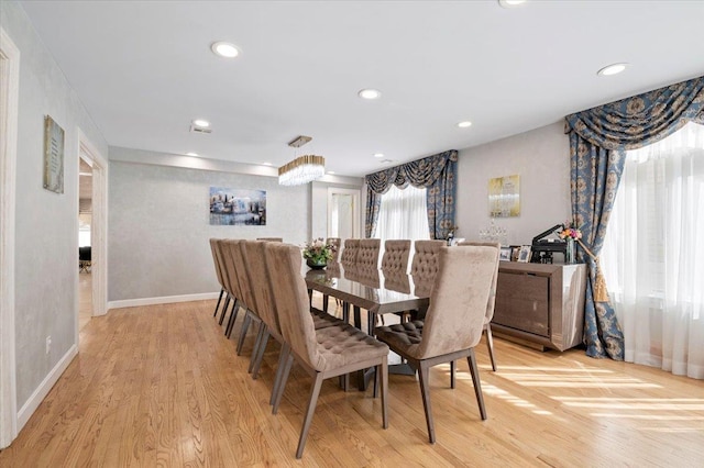 dining space featuring light wood-style floors, baseboards, and recessed lighting