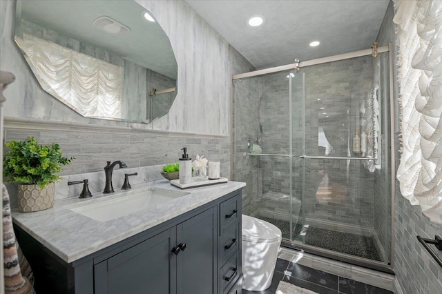 full bathroom with tile walls, recessed lighting, toilet, a shower stall, and vanity