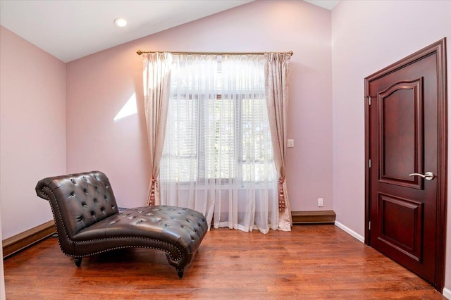 sitting room with recessed lighting, vaulted ceiling, baseboards, and wood finished floors