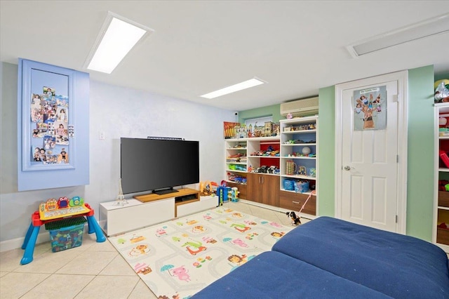 rec room featuring tile patterned floors, baseboards, and a wall mounted AC